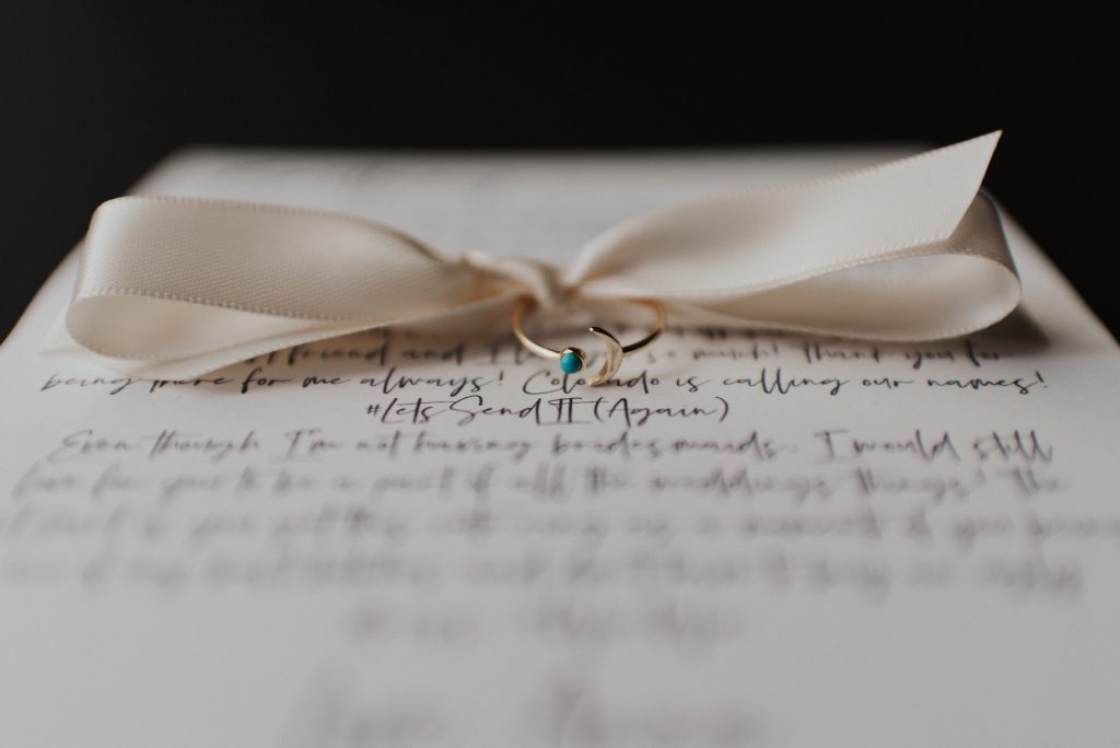 Turquoise rings and letters to best friends for elopement with white bow; Eloping Without a Bridal Party