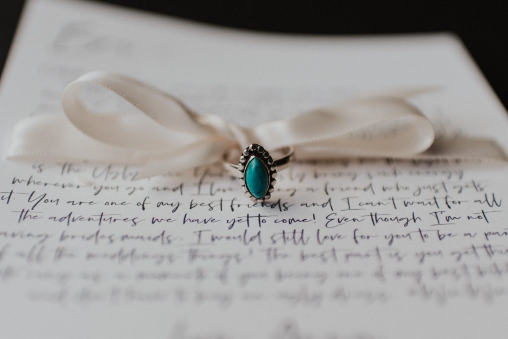 Turquoise rings and letters to best friends for elopement with white bow; Eloping Without a Bridal Party
