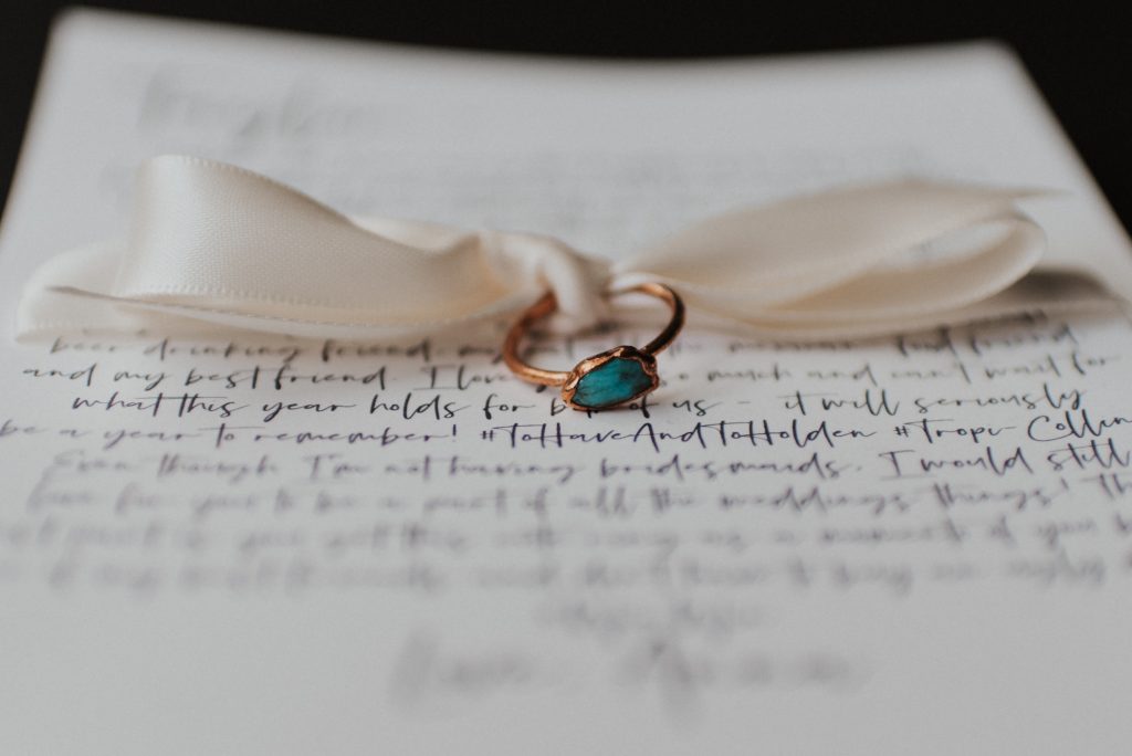 Turquoise rings and letters to best friends for elopement with white bow; Eloping Without a Bridal Party