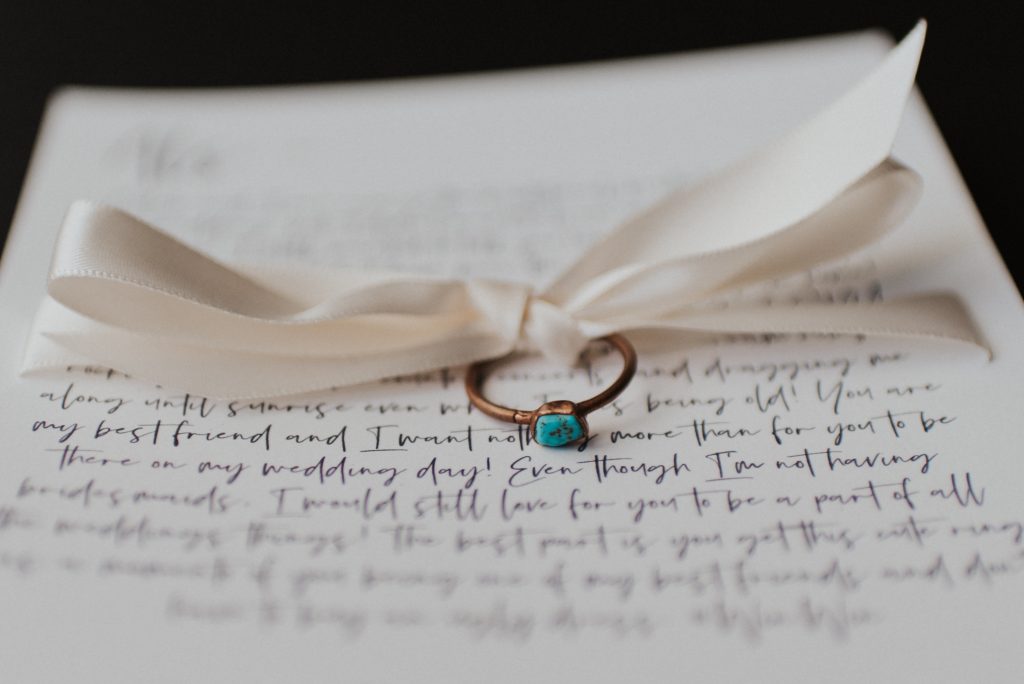 Turquoise rings and letters to best friends for elopement with white bow; Eloping Without a Bridal Party
