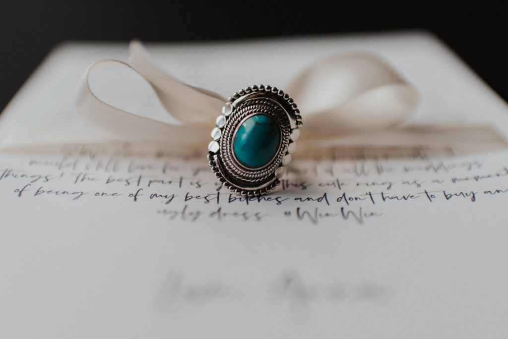 Turquoise rings and letters to best friends for elopement with white bow; Eloping Without a Bridal Party