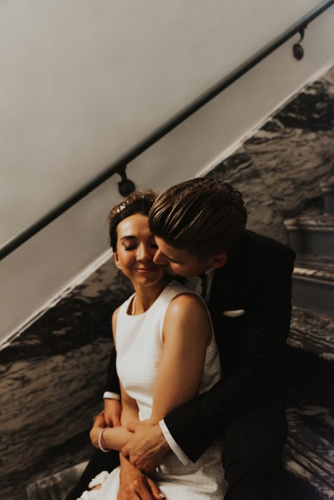 Bride and groom sitting on Le Meridien Tampa marble steps