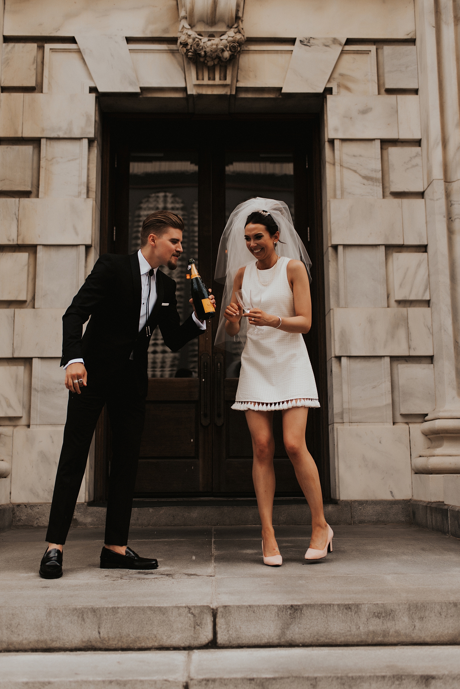 Bride and groom drinking champagne on Le Meridien Tampa steps