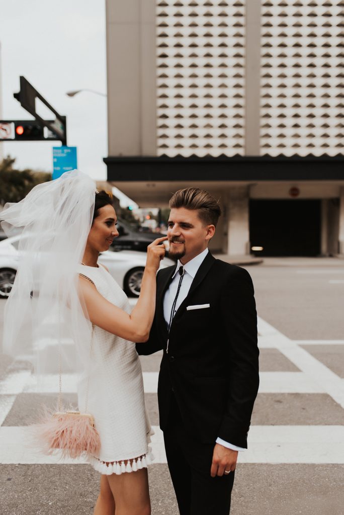 Bride and groom crossing downtown tampa street