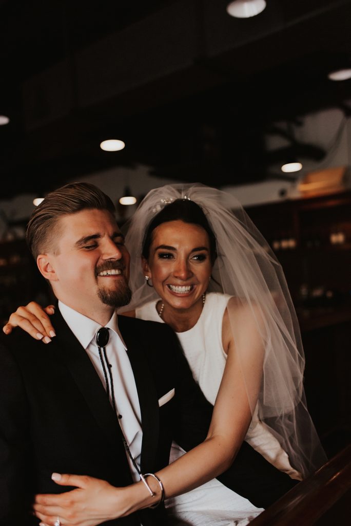 Bride and groom laughing in downtown tampa bar