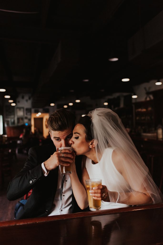 Bride and groom drinking craft beer in downtown tampa bar
