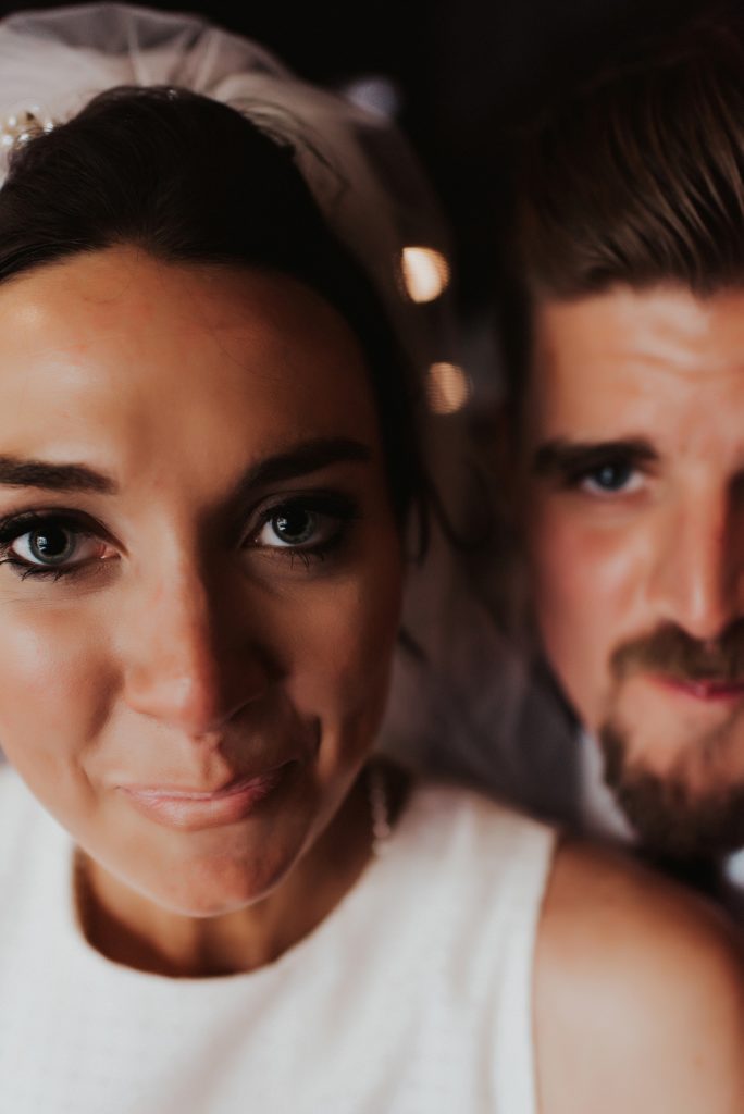 Close up of bride and groom drinking beer in downtown tampa bar
