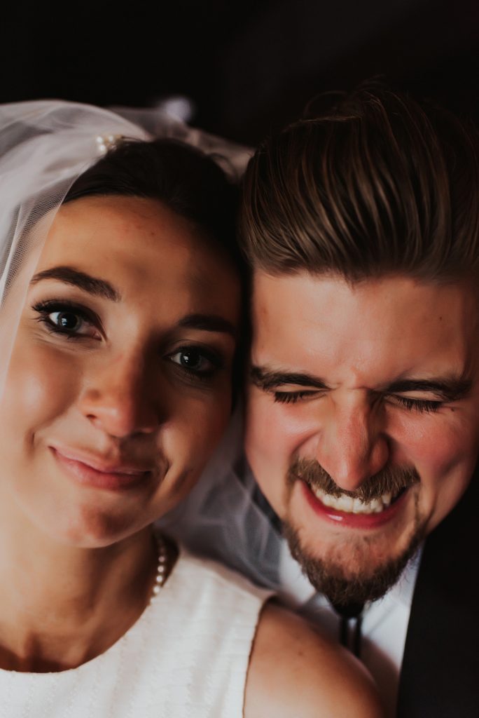 Close up of bride and groom drinking beer in downtown tampa bar