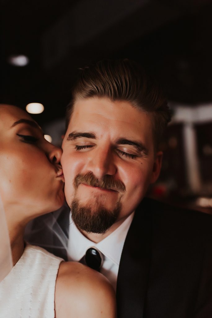 Close up of bride and groom drinking beer in downtown tampa bar