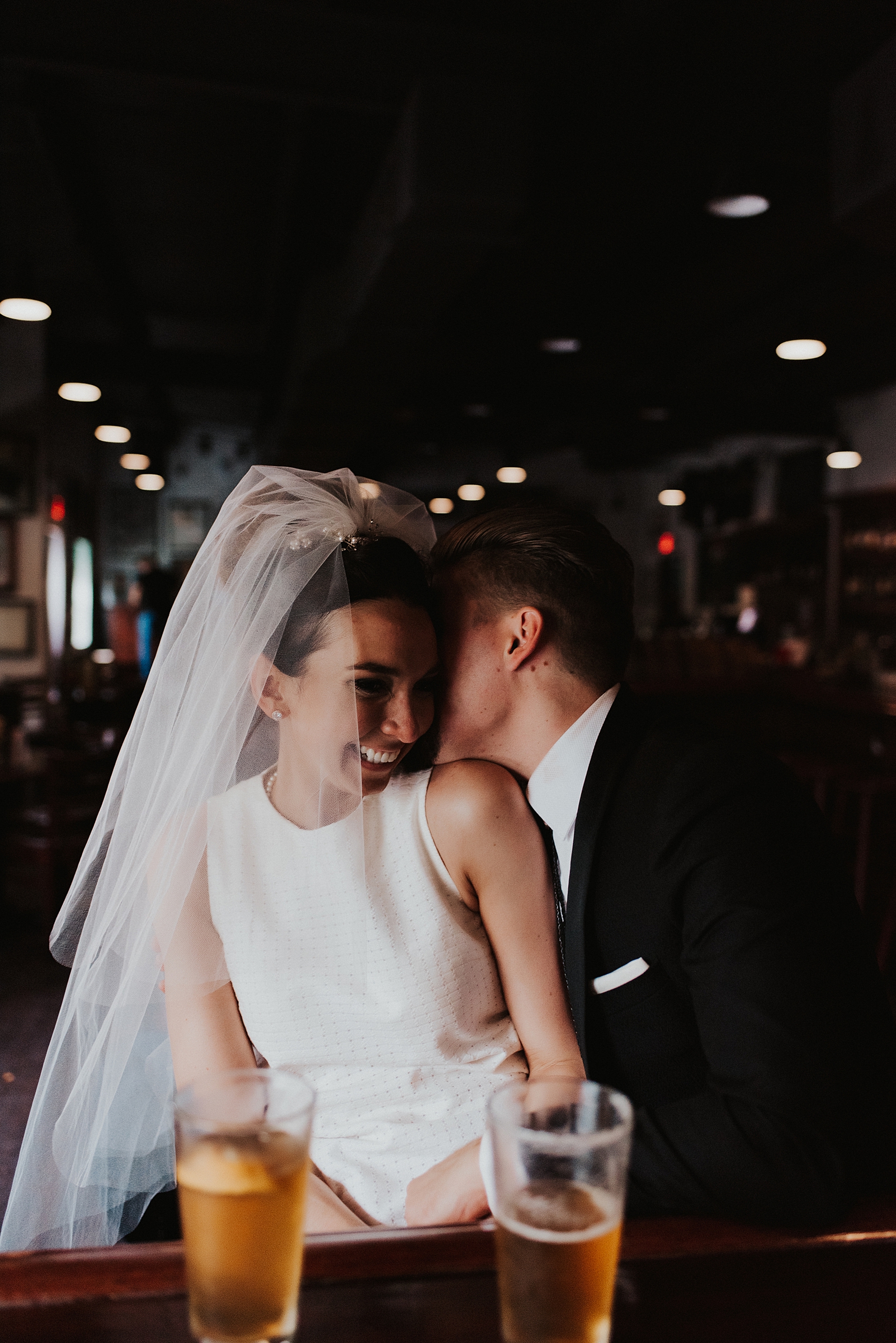 Groom whispering into brides ear