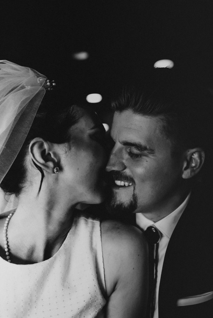 Bride and groom kissing in downtown tampa bar