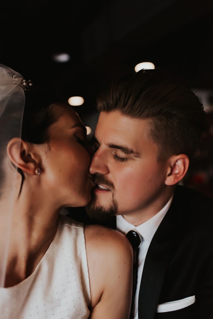 Bride and groom kissing in downtown tampa bar