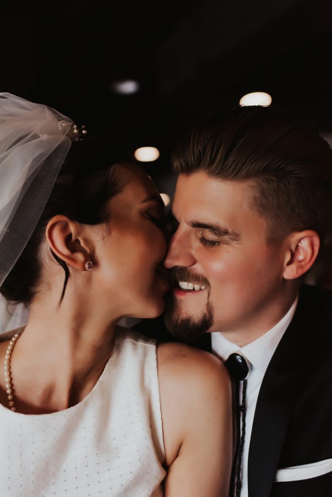 Bride and groom kissing in downtown tampa bar