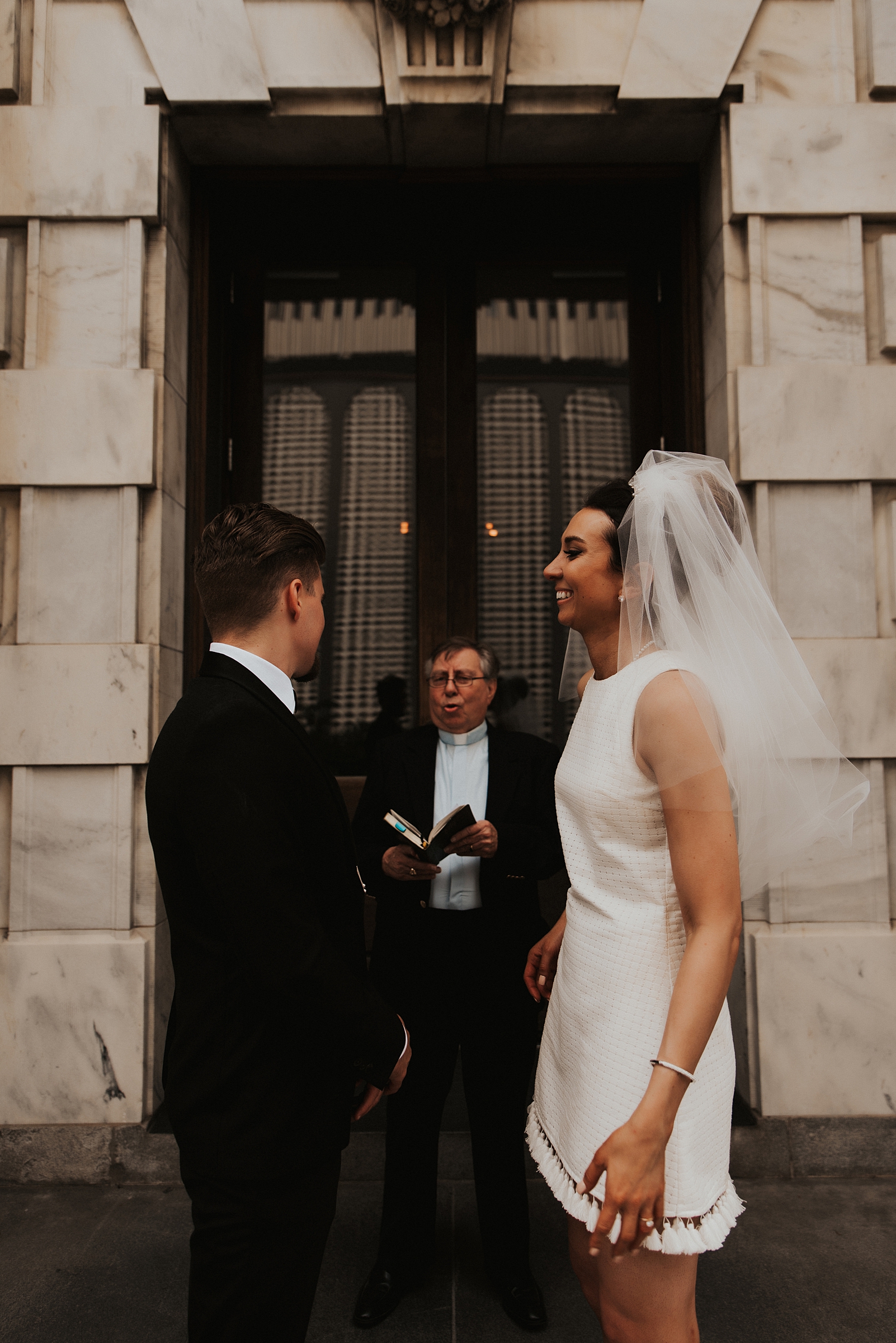 Pastor marrying bride and groom on front of Le meridien tampa steps