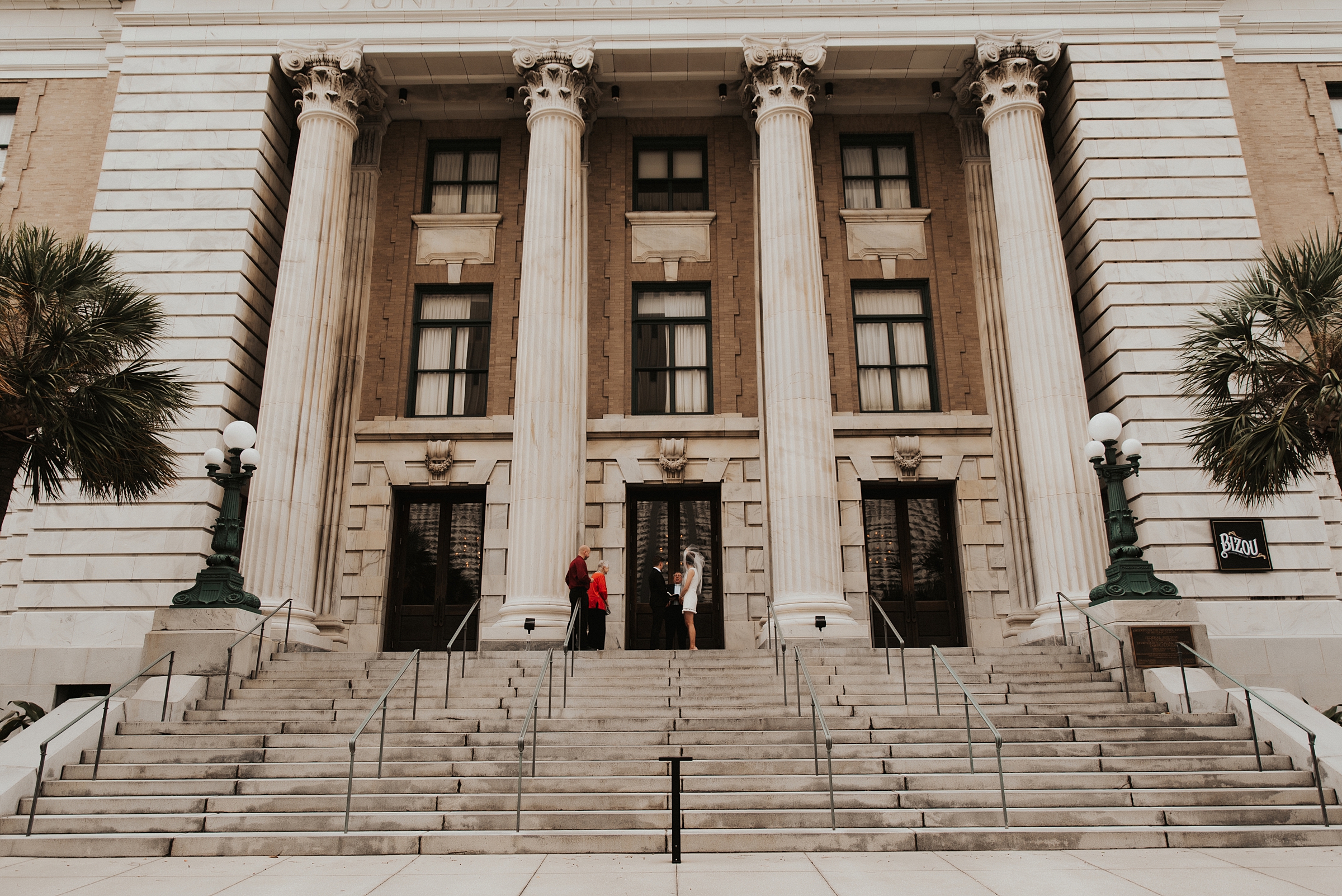 Pastor marrying bride and groom on front of Le meridien tampa steps