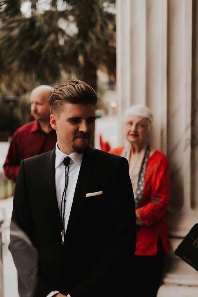 Groom in bolo tie on Le Meridien steps