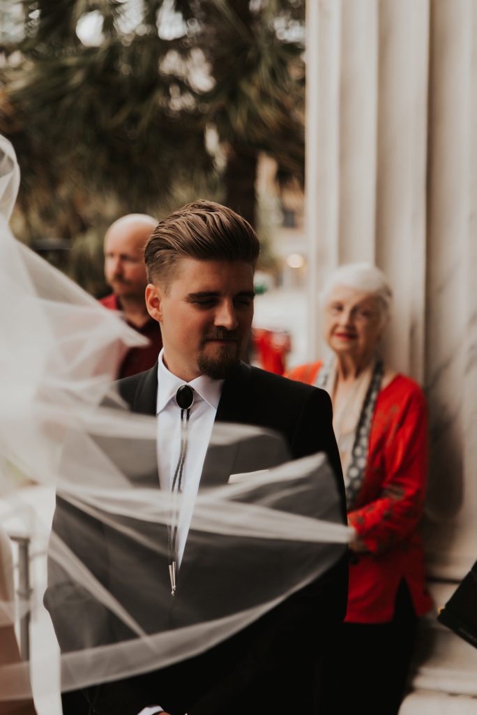 Groom in bolo tie on Le Meridien steps