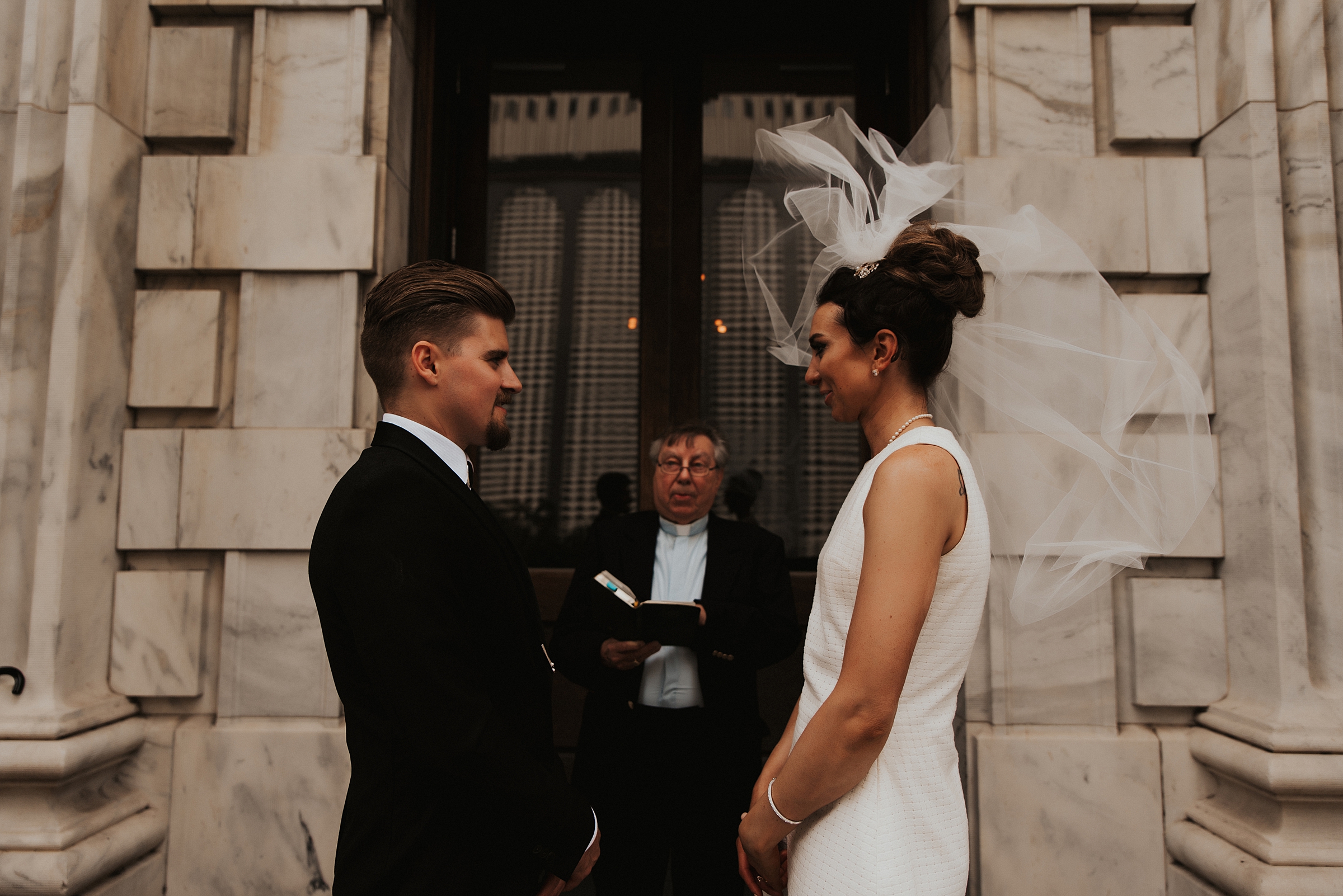 Brides veil flying in the wind on Le Meridien front steps