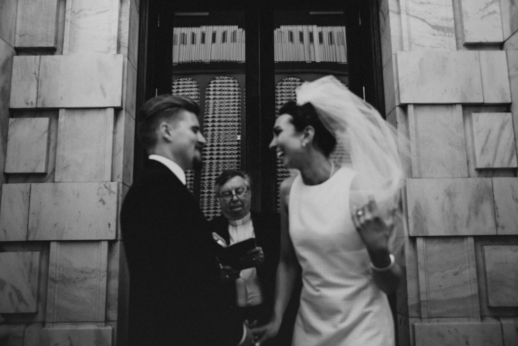 Bride and groom laughing during ceremony on Le Meridien Steps