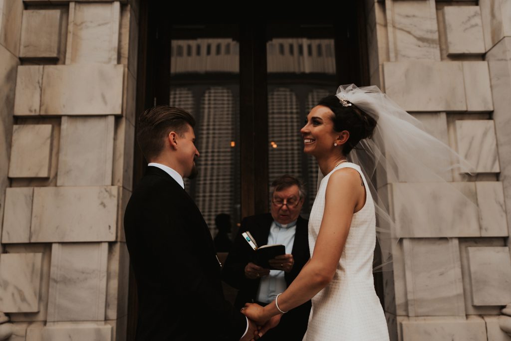 Bride and groom laughing during ceremony on Le Meridien Steps