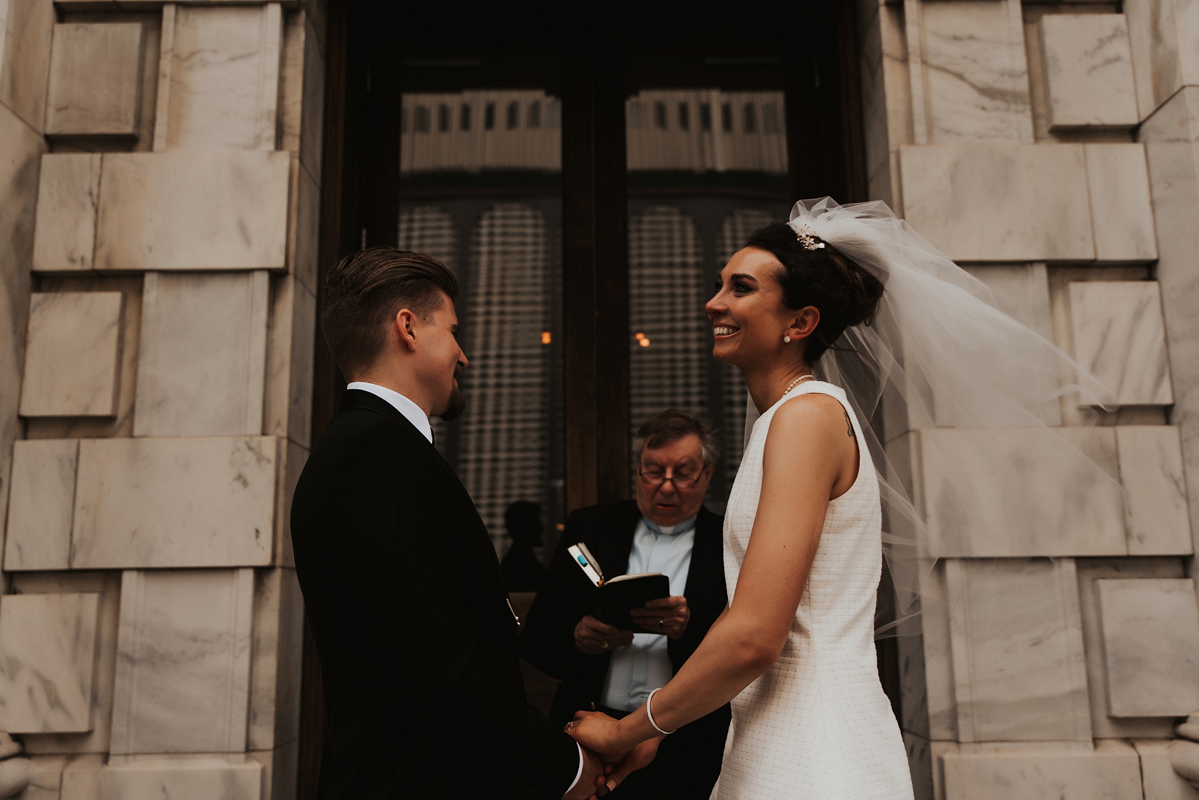 Bride and groom laughing during ceremony on Le Meridien Steps