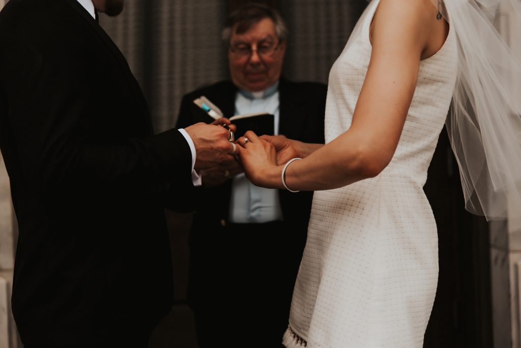 Bride and groom exchanging rings on front of Le Meridien tampa steps