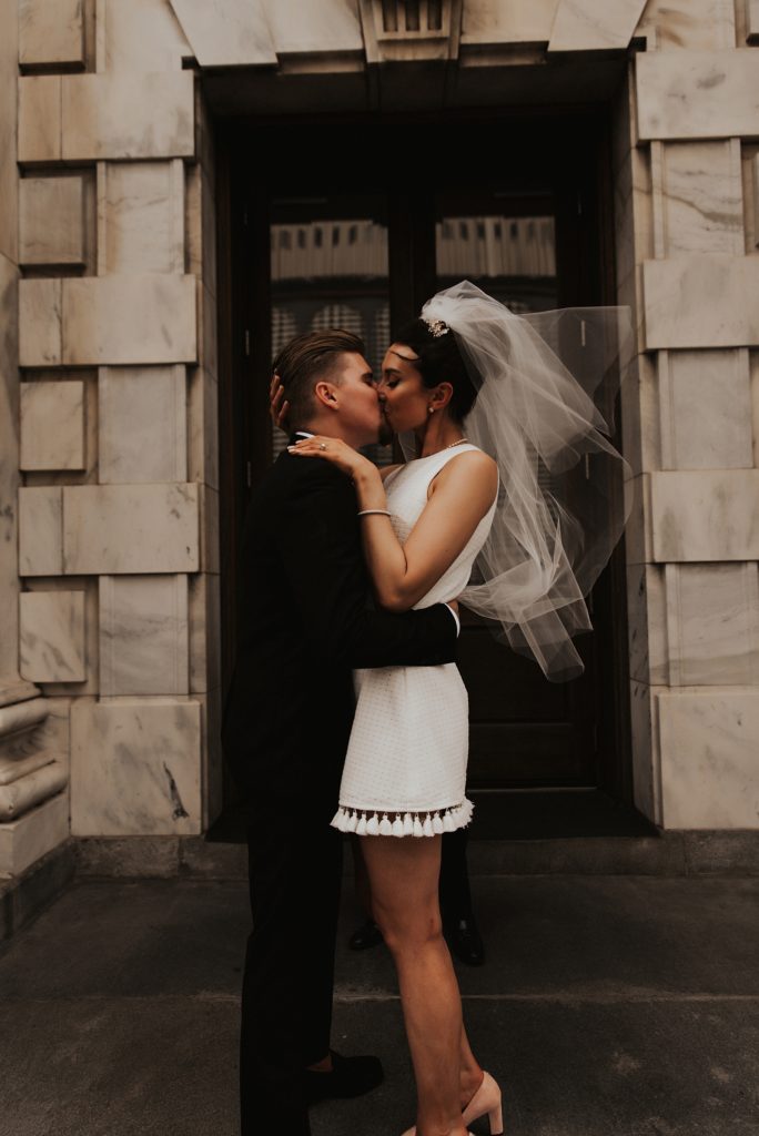 Bride and grooms first kiss on le meridien tampa front steps