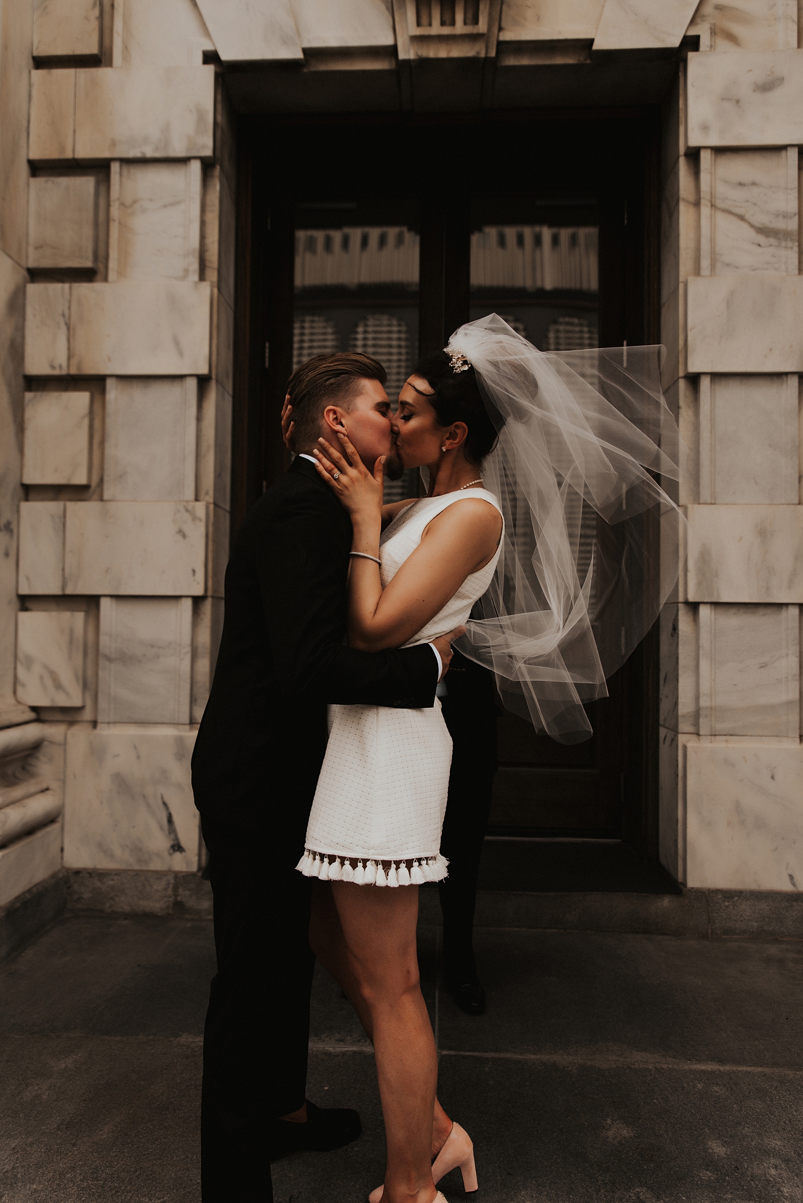Bride and grooms first kiss on le meridien tampa front steps