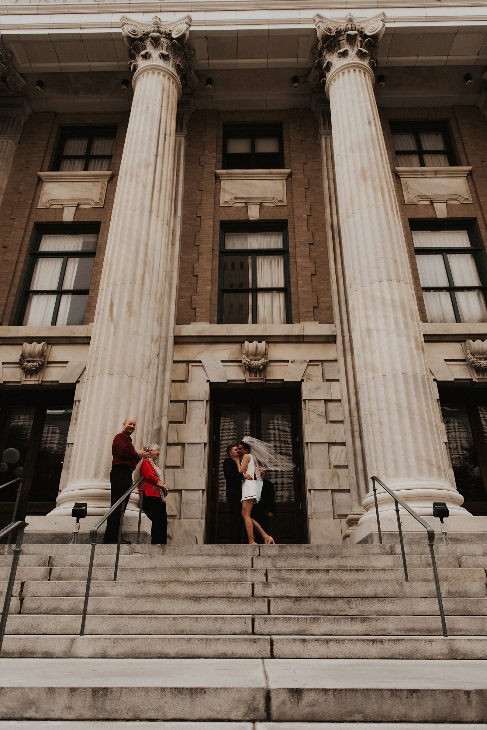 Bride and grooms first kiss on le meridien tampa front steps