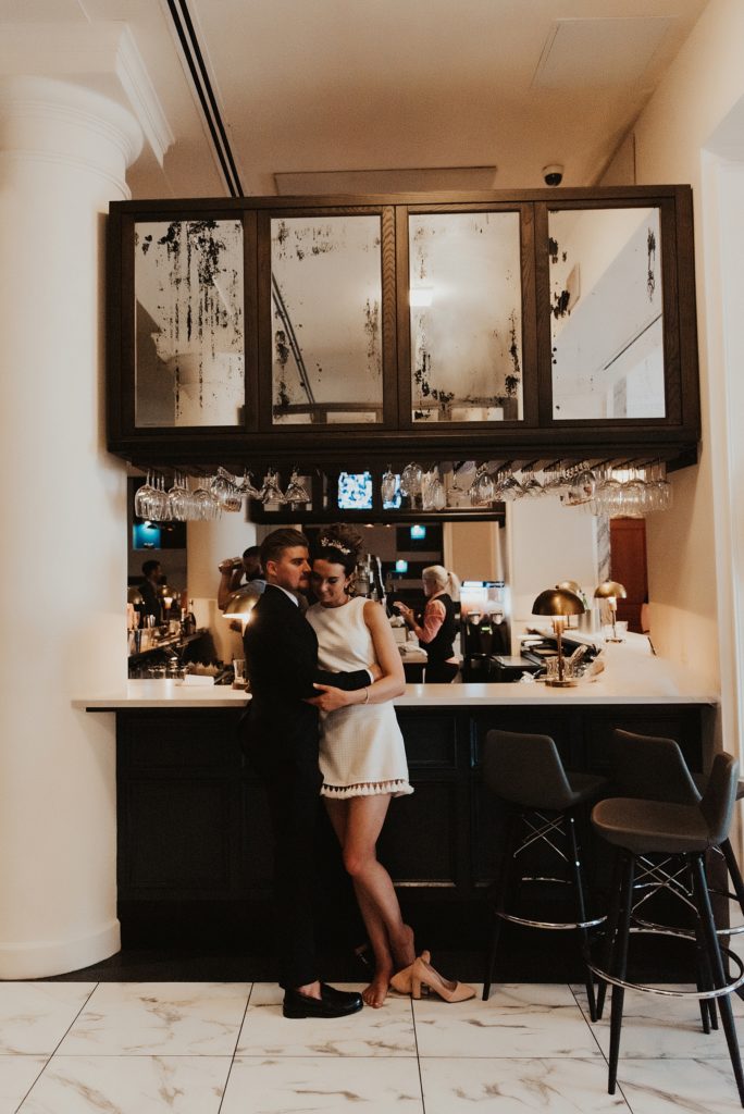 Bride and groom cuddling on bar inside of Le Meridien Tampa
