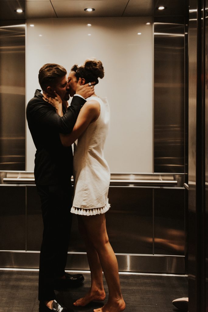 Bride and groom kissing in elevator in Le meridien tampa