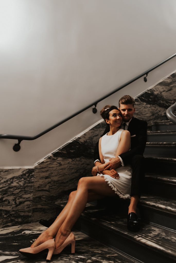 Bride and groom sitting on Le Meridien Tampa marble steps