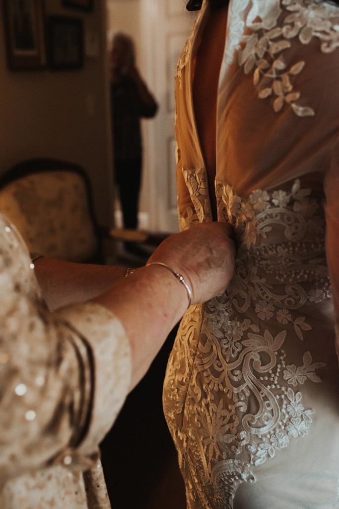 Wedding photography of bride getting ready with mother