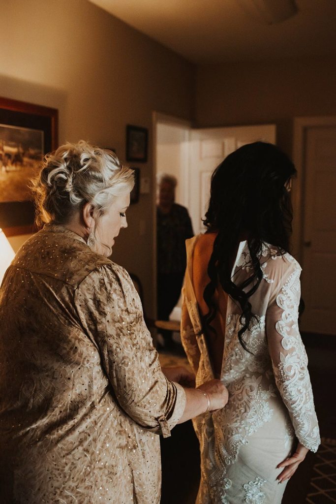 Wedding photography of bride getting ready with mother