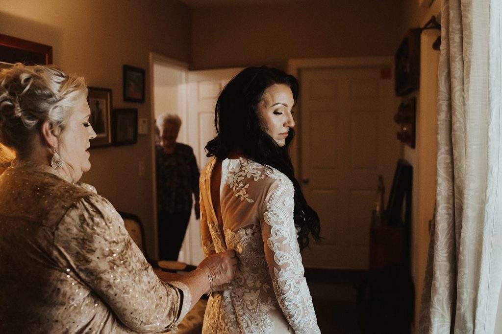 Wedding photography of bride getting ready with mother