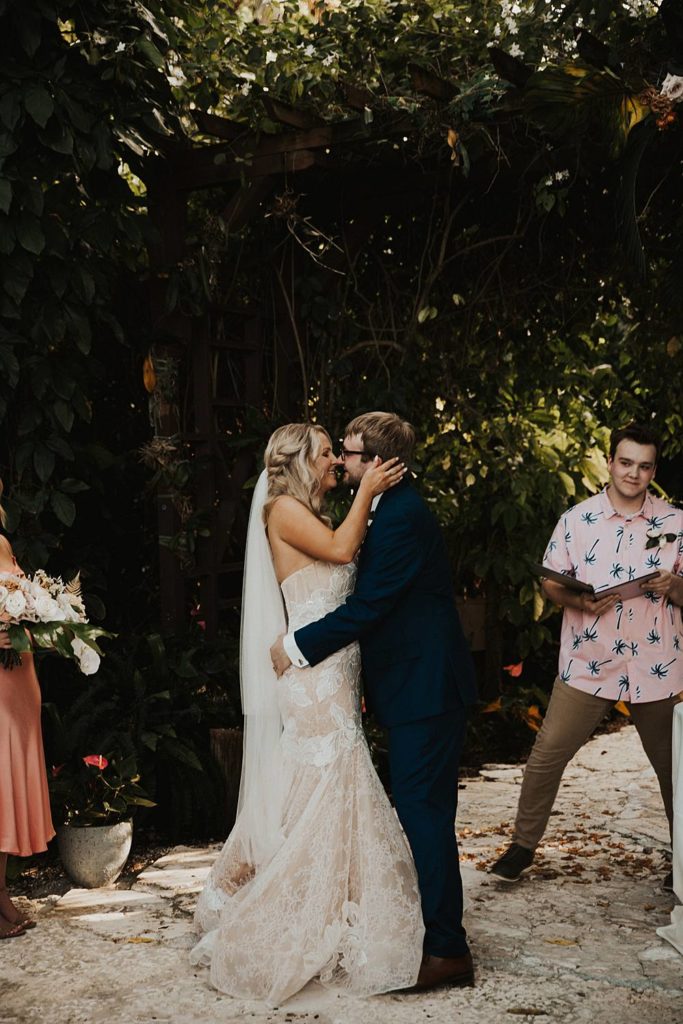 Bride and groom first kiss at the historic walton house in homestead florida