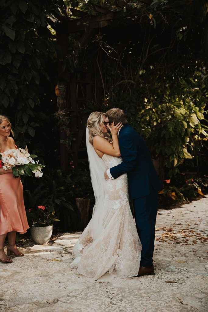 Bride and groom first kiss at the historic walton house in homestead florida