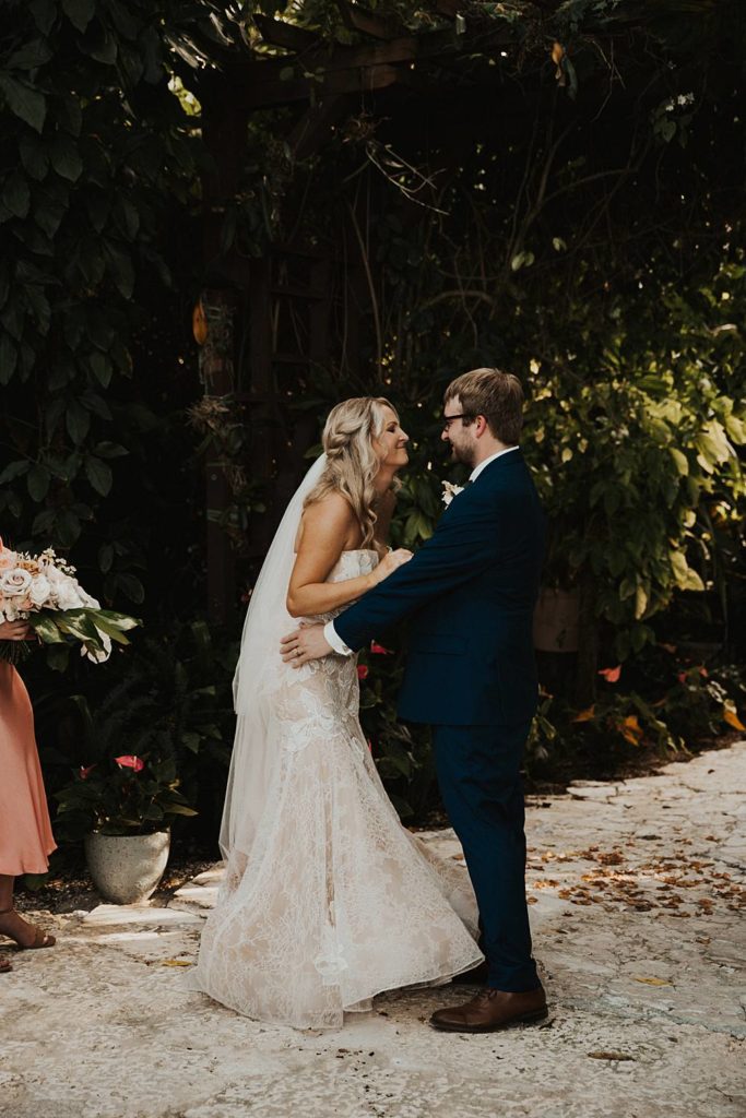 Bride and groom first kiss at the historic walton house in homestead florida