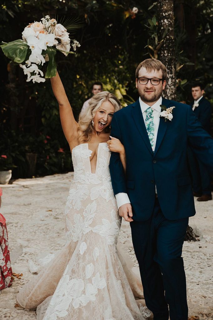 Bride and groom exit the ceremony at the historic walton house in homestead florida