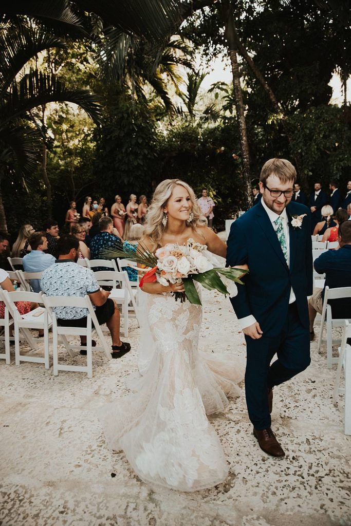 Bride and groom exit the ceremony at the historic walton house in homestead florida