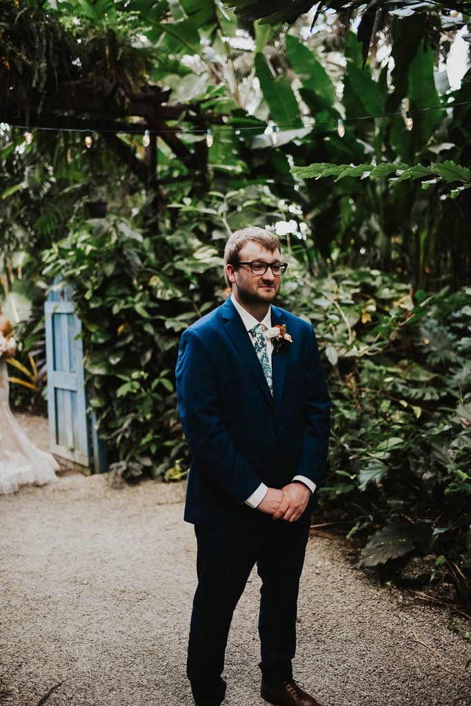 Groom waiting for first look at the Historic Walton House in Homestead Florida