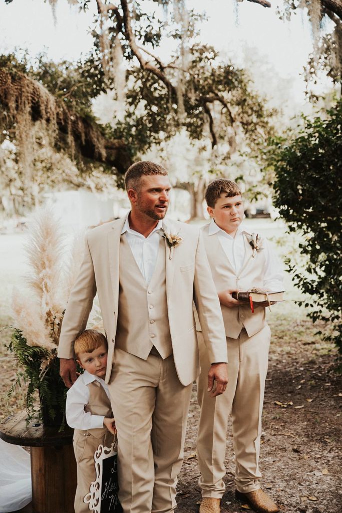 Groom waiting at alter watching bride walk down the aisle at okeechobee wedding