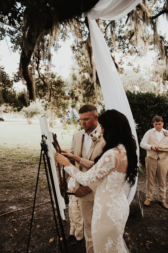 Bride and groom tying the knot during okeechobee wedding ceremony