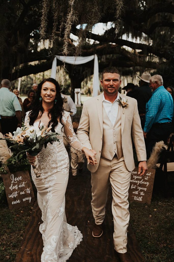 Bride and groom walking back down the aisle after getting married in outdoor ceremony in okeechobee florida