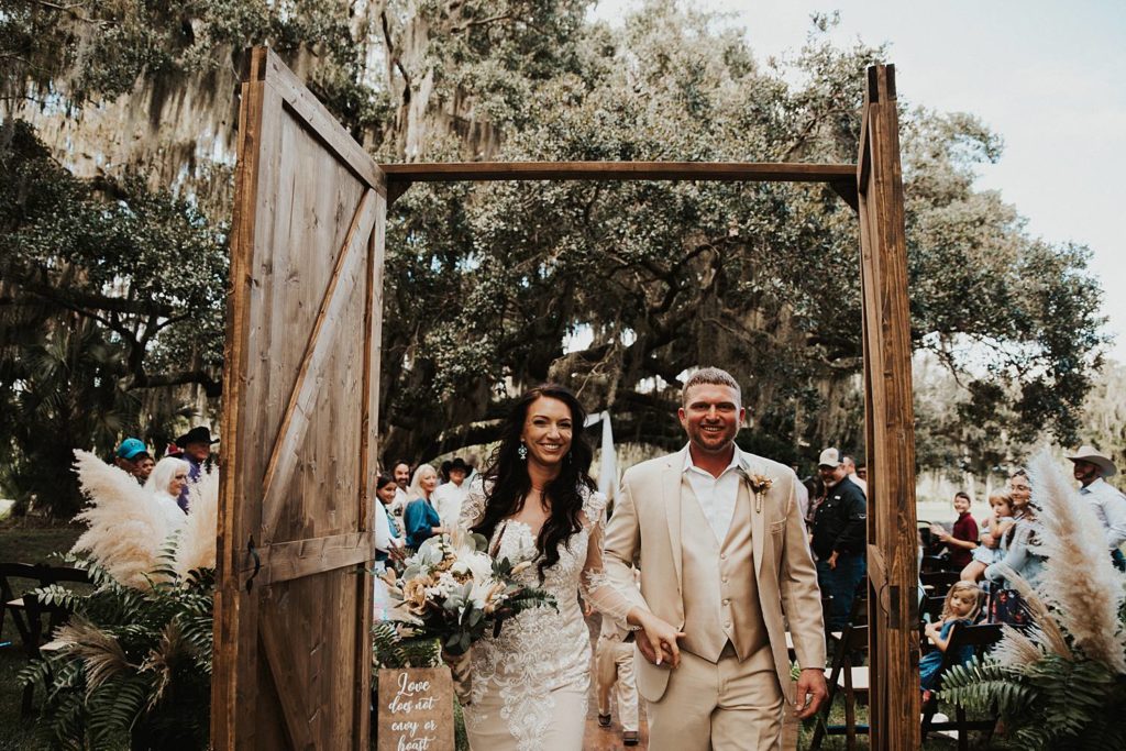 Bride and groom walking back down the aisle after getting married in outdoor ceremony in okeechobee florida