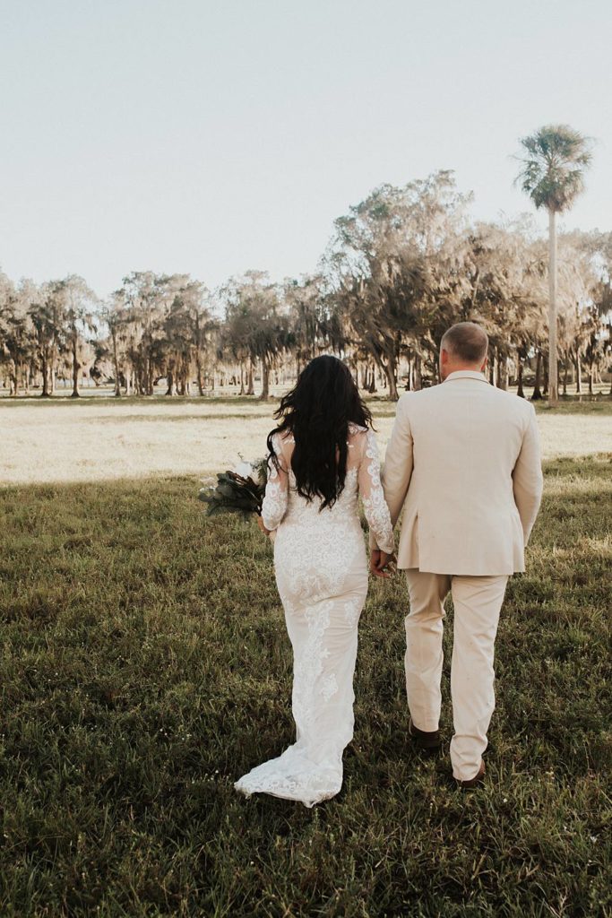 Bride and groom walking back down the aisle after getting married in outdoor ceremony in okeechobee florida