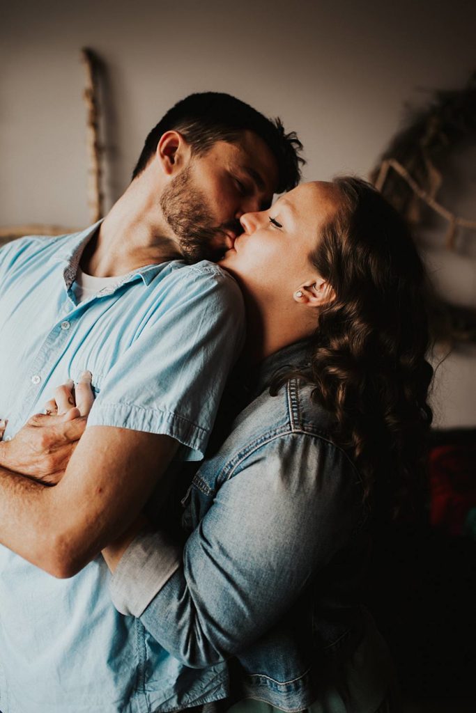 Couple kissing inside brewery