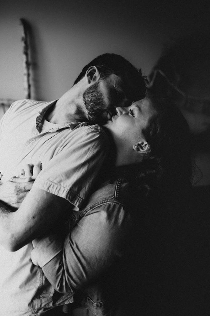 Couple kissing inside brewery