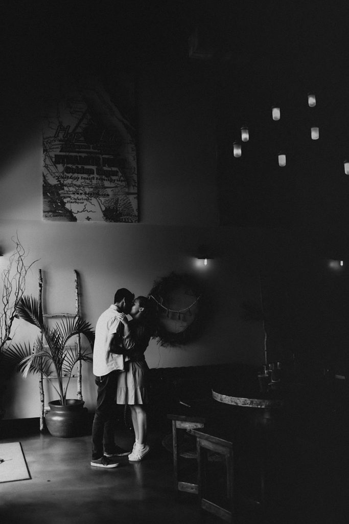 Couple kissing inside brewery