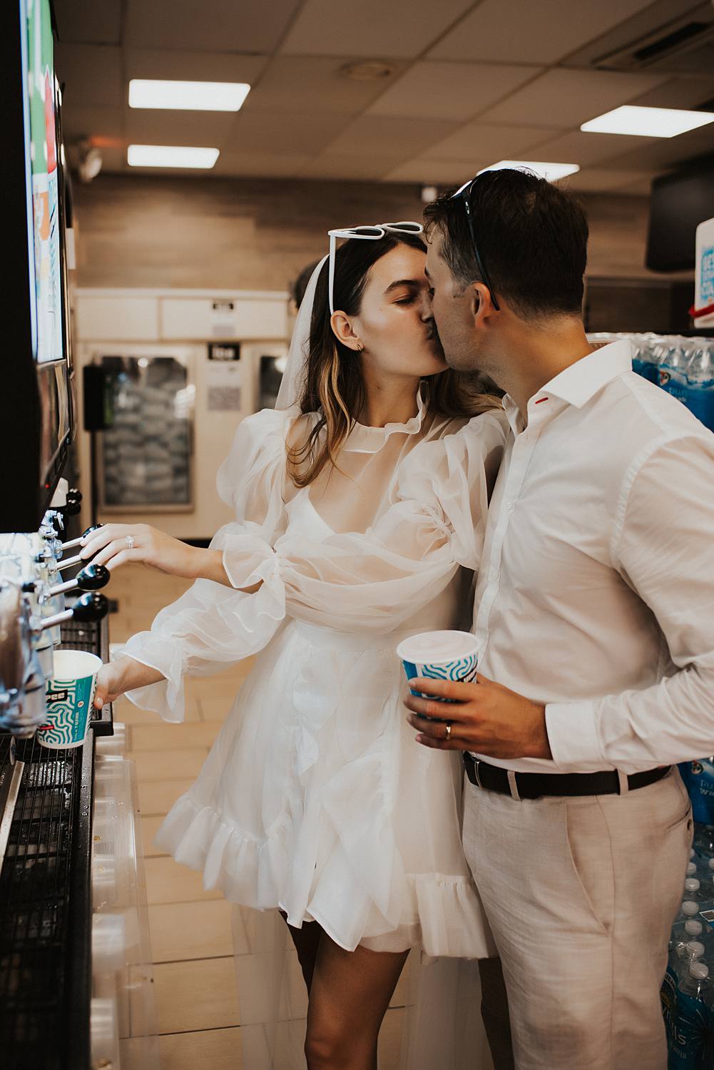 Bride and groom filling slurpie cups at 7 eleven